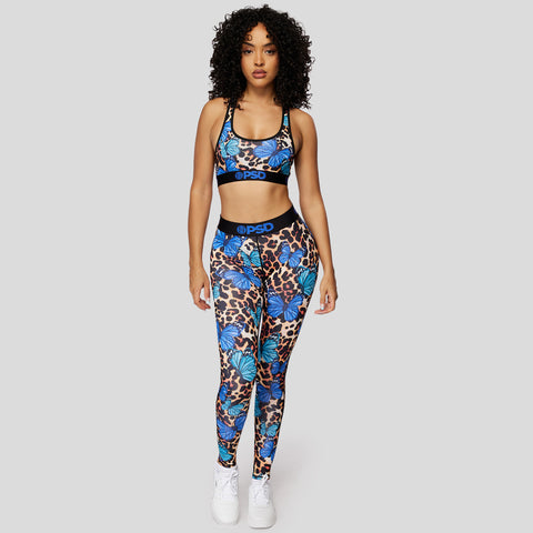 woman wearing cheetah print with blue butterflies women's sports bra and women's leggings set | PSD New Zealand