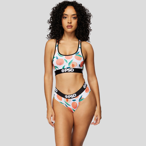 curly haired model wearing peach print sommer ray cheeky underwear | PSD New Zealand